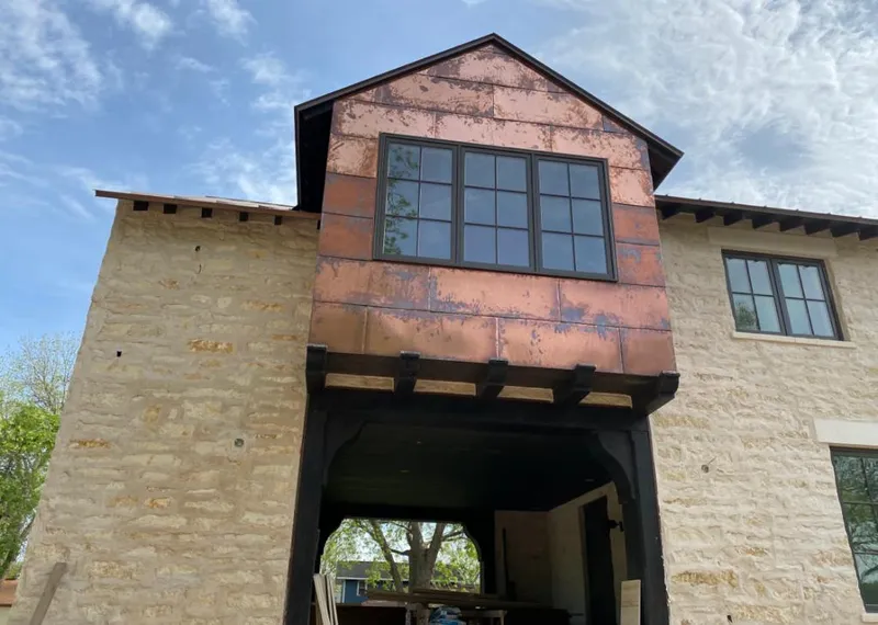 Copper metal panel facade on a stone building for Metal Roof Coating in Marshall
