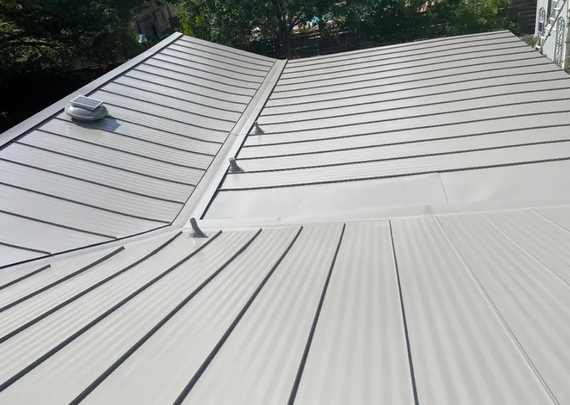 Solar attic fan installed on a metal roof for Roof Ventilation in Marshall